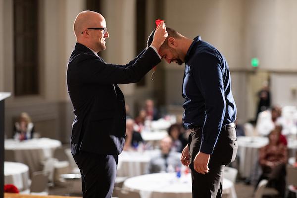 A person receiving a medal around their neck